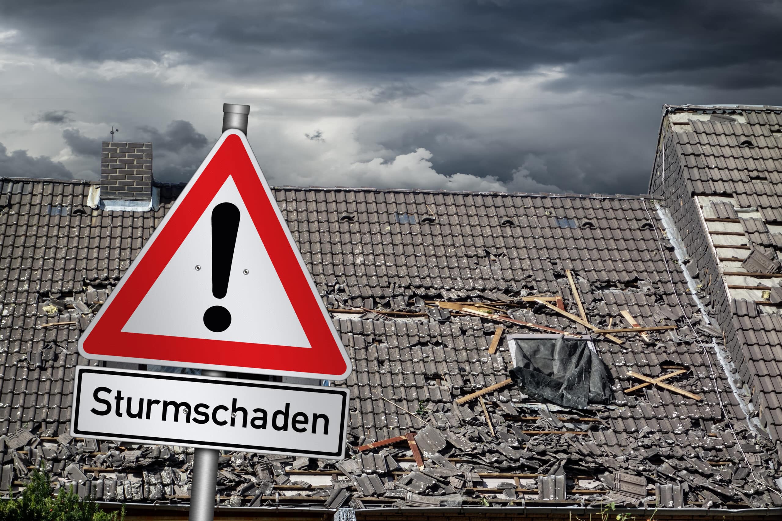 Kaputtes Dach durch Sturmschäden. Signalschild mit dem Wort Sturmschaden